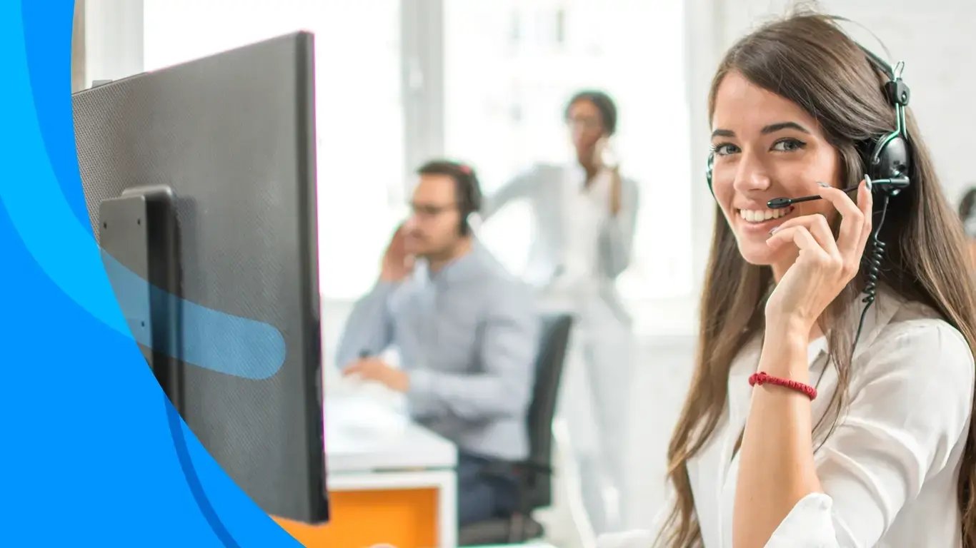 Call center agent with headset smiling at camera, colleagues visible in background